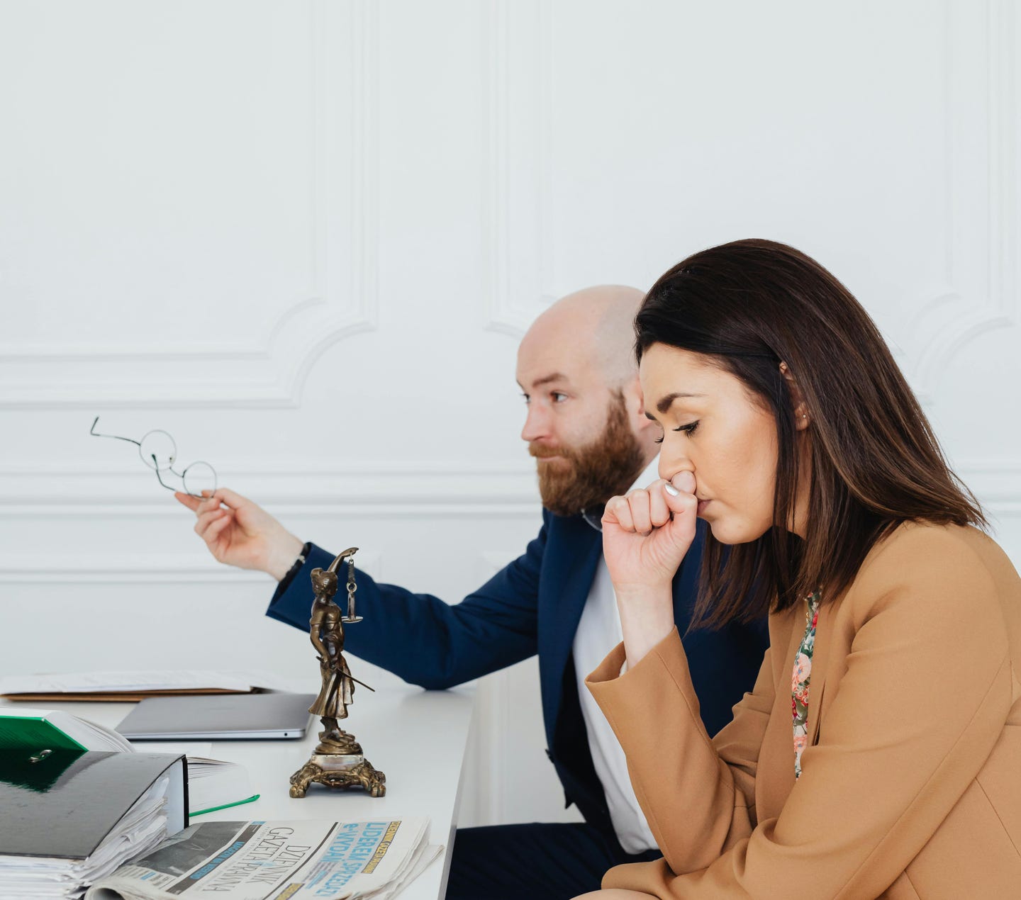 Woman Sitting with Her Hand Touching Her Nose 